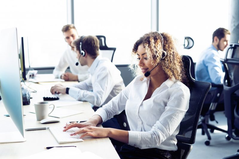 Female customer support operator with headset and smiling Female customer support operator with headset and smiling