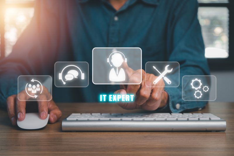 IT expert concept, Person hand using computer with IT expert icon on virtual screen, Information Technology Advice or Services. IT expert concept, Person hand using computer with IT expert icon on virtual screen, Information Technology Advice or Services.