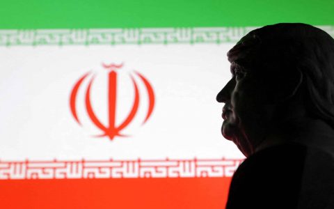 Illustration shows 3D printed miniature model of U.S. President Donald Trump and Iran flag