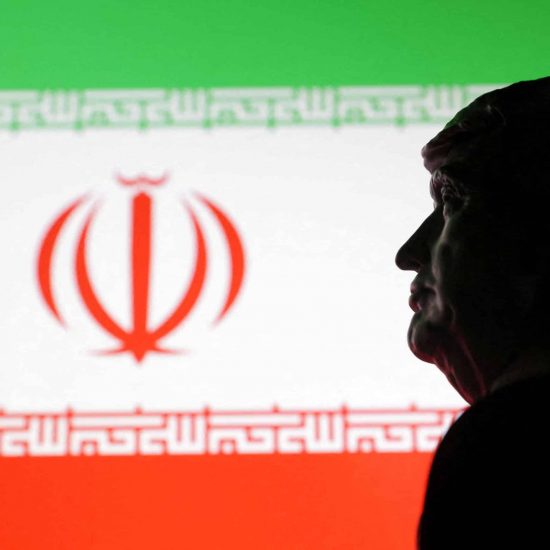 Illustration shows 3D printed miniature model of U.S. President Donald Trump and Iran flag