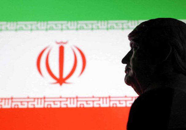 Illustration shows 3D printed miniature model of U.S. President Donald Trump and Iran flag