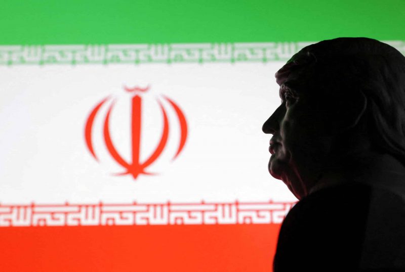 Illustration shows 3D printed miniature model of U.S. President Donald Trump and Iran flag